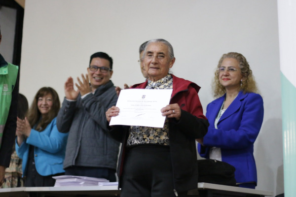 Mujer recicladora de oficio recibe diploma que la certifica en competencias laborales relacionadas con separación de residuos, otrogado por el Servicio Nacional de Aprendizaje SENA.