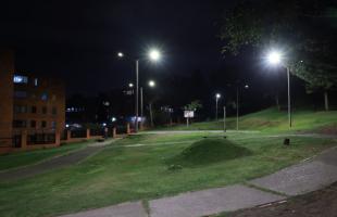 Foto panorámica nocturna del Parque Las Palmas II en la localidad de Suba, se evidencian cinco luminarias con tecnología tipo led, que iluminan la cancha y senderos del parque.