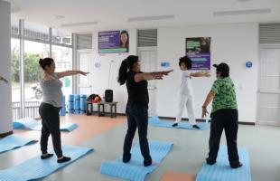 Mujeres están realizando ejercicios de yoga, servicio que se prestará en la Manzana del Cuidado.