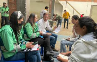 Funcionarios de la UAESP con chaqueta verde, atienden a los carreteros.